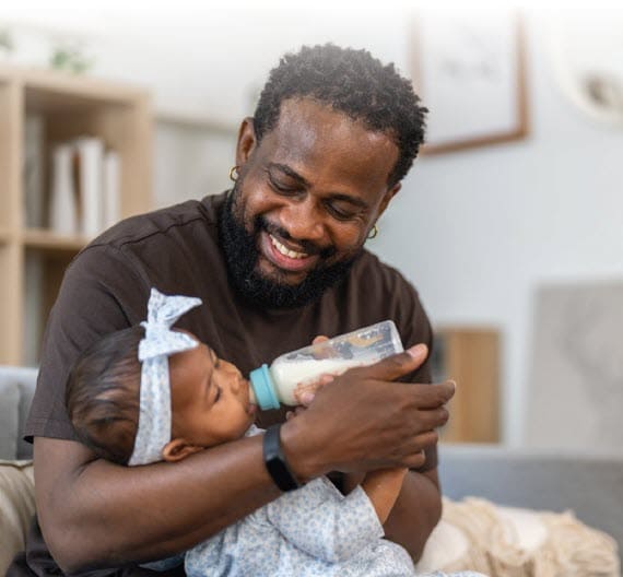 Man feeding baby