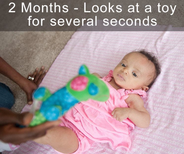 A baby looking at a toy