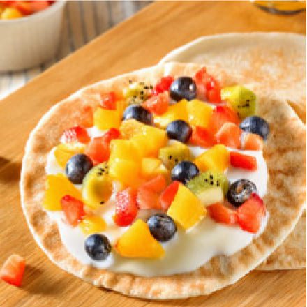 Rainbow Fruit Pizza on a cutting board